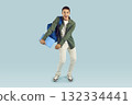 Happy excited student boy holding textbook with backpack isolated on blue studio background. 132334441