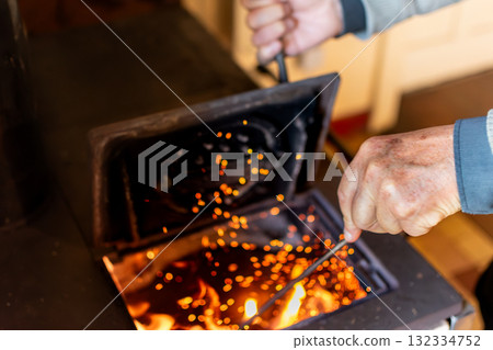 Wood stove in a house for heating and cooking, real life photo Wood stove in a house for heating and cooking, real life photo 132334752