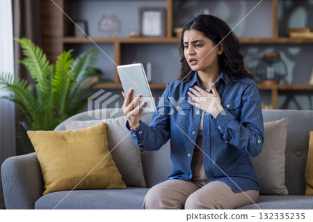 A smiling, beautiful woman wearing a black hijab and a yellow blouse, looks directly at the camera. A smiling, beautiful woman wearing a black hijab and a yellow blouse, looks directly at the camera. 132335235