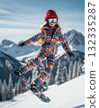 An adventurous and stylish fashion doll is captured mid-air, skillfully riding a snowboard down a snowy mountain 132335287