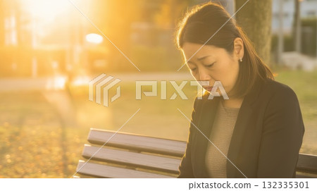 Depressed woman sitting on a bench 132335301