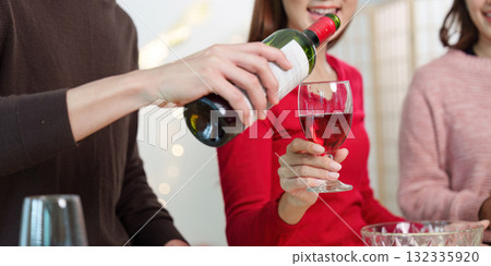 Pouring Red Wine for Happy New Year Toast Pouring Red Wine for Happy New Year Toast 132335920