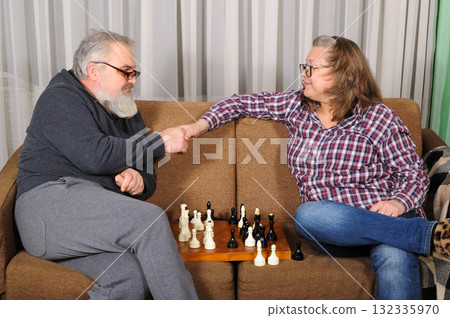 An elderly couple playing chess 132335970