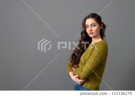 portrait of beautiful sensual woman with long curly hair against gray background portrait of beautiful sensual woman with long curly hair against gray background 132336279