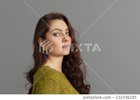 close-up portrait of beautiful sensual female with long curly hair against gray background close-up portrait of beautiful sensual female with long curly hair against gray background 132336285