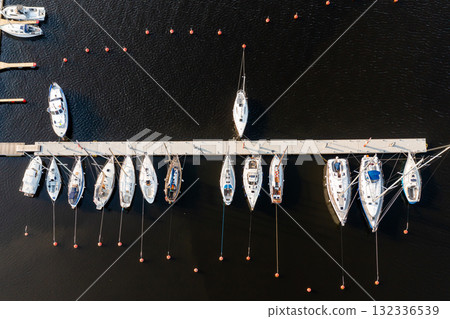 Top view of yachts at pier on dark sea water background 132336539