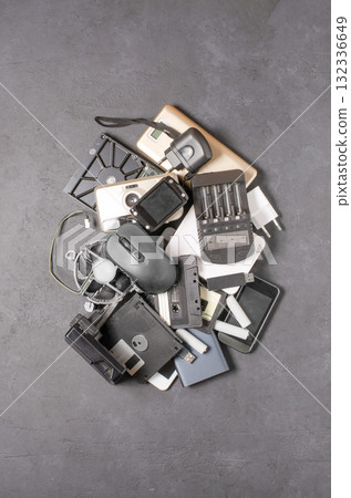 Old electronic devices on a black background. The concept of recycling used gadgets. Old electronic devices on a black background. The concept of recycling used gadgets. 132336649