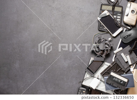 Old electronic devices on a black background. The concept of recycling used gadgets. Copy space Old electronic devices on a black background. The concept of recycling used gadgets. Copy space 132336650