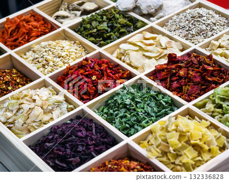 Colorful array of dried herbs and spices displayed in a wooden box at a local market Colorful array of dried herbs and spices displayed in a wooden box at a local market 132336828