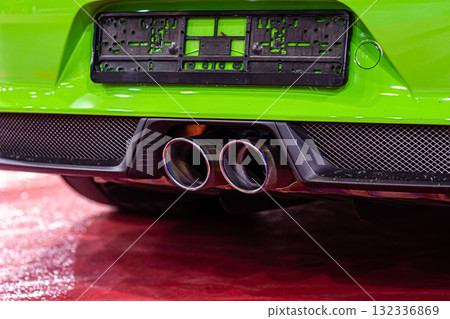close-up of modern sporty car dual exhaust pipes, vehicle smog polluting the air 132336869