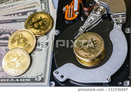 Bitcoin BTC coins, open hard drive and dollar bills, digital payment system concept Bitcoin BTC coins, open hard drive and dollar bills, digital payment system concept 132336897