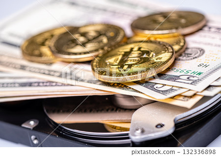 Bitcoin BTC coins, open hard drive and dollar bills, digital payment system concept 132336898