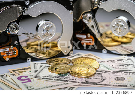 Bitcoin BTC coins, open hard drive and dollar bills, digital payment system concept 132336899