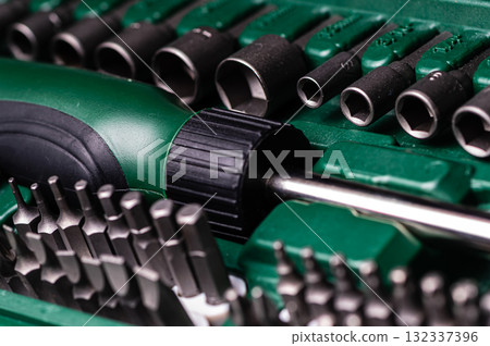 Interchangeable screwdriver set with different types of metal steel heads and bits, closeup 132337396