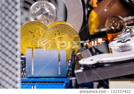 closeup of gold bitcoin on computer components background, technology and digital currency concept 132337422