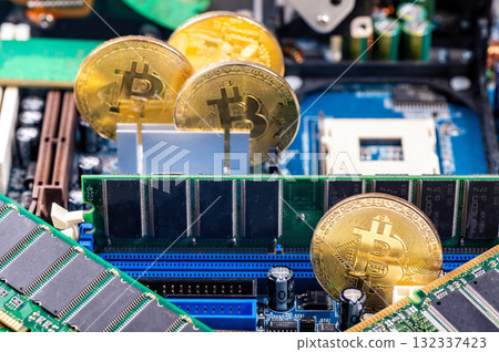 closeup of gold bitcoin on computer components background, technology and digital currency concept 132337423