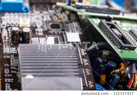electronic circuit and cooling fin at computer video card, stack with used video cards, closeup 132337437