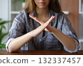 Woman hands gesturing x or stop on a table 132337457