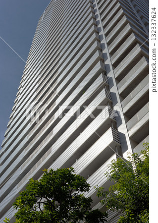 High-rise apartment rising in blue sky 132337624