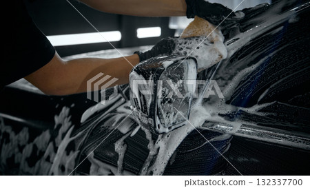 Close-up of hand washing car mirror with foam sponge during detailing Close-up of hand washing car mirror with foam sponge during detailing 132337700