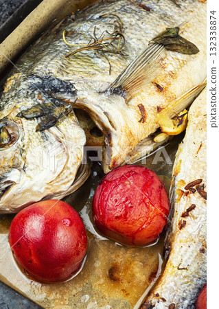 Whole fried dorado in baking sheet. 132338874