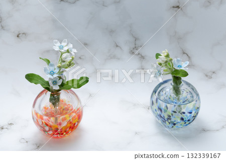 Blue stars arranged in a clear glass vase (left and right) Blue stars arranged in a clear glass vase (left and right) 132339167