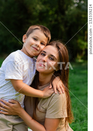 Image of happy mother and son outside in public park. Ideal for themes of parenting, motherhood and family relationships 132339214