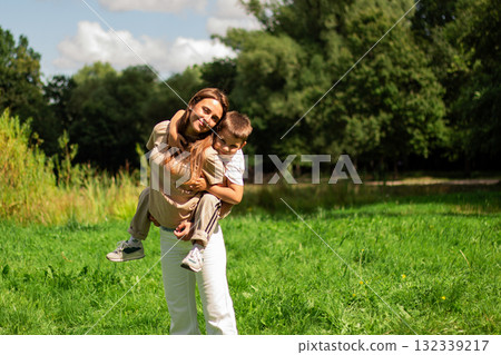 Six years old boy and his mom twirl together and laughing. Heartwarming display of mother son fun and connection. 132339217