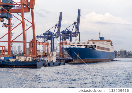 Bosphorus harbor with cargo ship and cranes working during a cloudy day 132339416