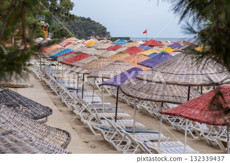 Colorful beach umbrellas line the sandy shore at Prince Islands creating a vibrant vacation atmosphere on a sunny day Colorful beach umbrellas line the sandy shore at Prince Islands creating a vibrant vacation atmosphere on a sunny day 132339437