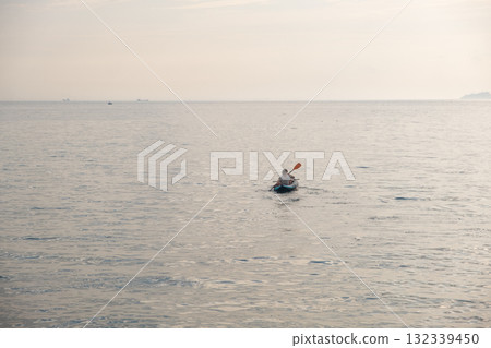 Kayaking on calm waters around Prince Islands during sunrise offers a serene experience and breathtaking views of nature 132339450