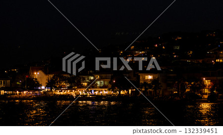 Evening view of waterfront cafes and illuminated buildings in Prince Islands at night 132339451