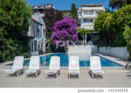 Relaxing poolside retreat with vibrant bougainvillea in Prince Islands during sunny summer day Relaxing poolside retreat with vibrant bougainvillea in Prince Islands during sunny summer day 132339458