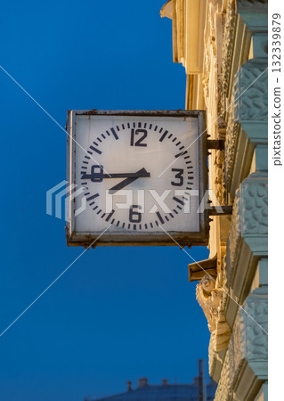Vintage clock tower near street in St Petersburg during twilight showcasing classic architectural details and urban ambiance 132339879