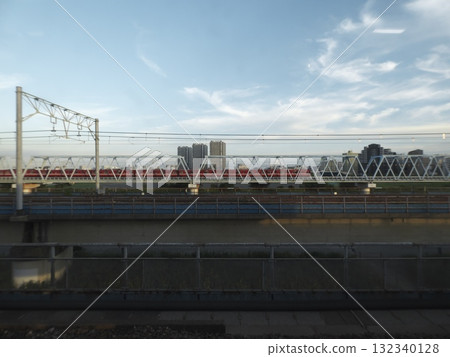 Keikyu Main Line and railway bridge crossing the Tama River, the skyline before dusk and buildings Keikyu Main Line and railway bridge crossing the Tama River, the skyline before dusk and buildings 132340128