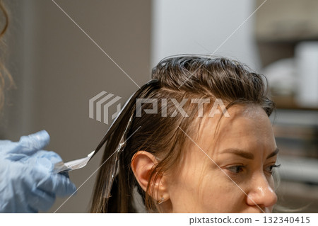 Hair coloring process in a modern salon showcasing vibrant transformation during a relaxing treatment Hair coloring process in a modern salon showcasing vibrant transformation during a relaxing treatment 132340415
