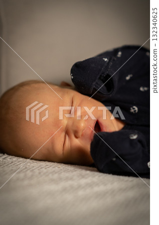Baby sleeping peacefully on a soft blanket in a cozy indoor setting during the afternoon Baby sleeping peacefully on a soft blanket in a cozy indoor setting during the afternoon 132340625