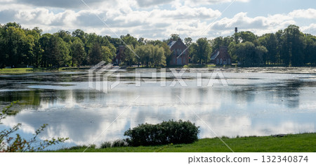 Reflections of the Great Catherine Palace in serene waters with surrounding greenery Reflections of the Great Catherine Palace in serene waters with surrounding greenery 132340874
