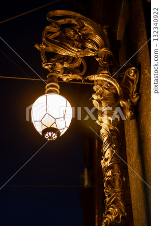 Decorative lamp detail on a historic building in St Petersburg showcasing intricate design at night 132340922