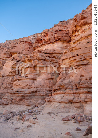 Exploring the unique rock formations and vibrant colors of Tsvetnoy Canyon in Egypt during a clear day 132340944
