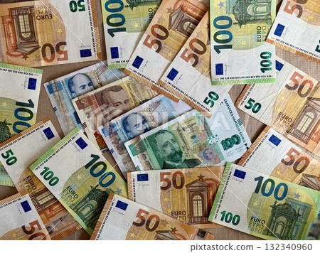 Euro banknotes mixed with Bulgarian lev notes, symbolizing upcoming currency shift in Bulgaria starting 2026. Concept of eurozone expansion and Bulgarian euro integration Euro banknotes mixed with Bulgarian lev notes, symbolizing upcoming currency shift in Bulgaria starting 2026. Concept of eurozone expansion and Bulgarian euro integration 132340960