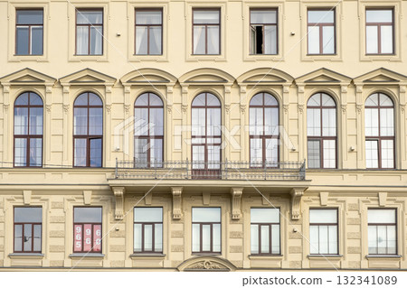 Architectural details of a historic building in Saint Petersburg showcasing elegant design and large windows during daylight 132341089