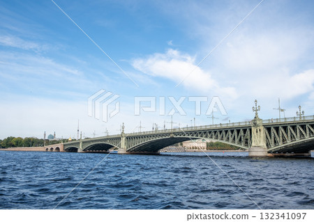 Bridge over the water in Saint Petersburg surrounded by blue sky and trees during daylight 132341097