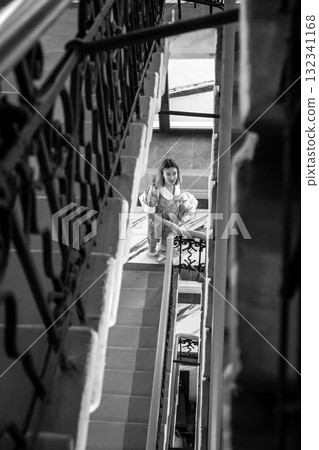 Woman descending stairs in black and white Woman descending stairs in black and white 132341168