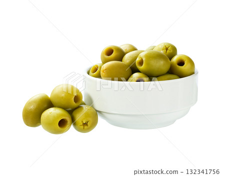 pitted green olives in a white ceramic bowl isolated on a white background. 132341756