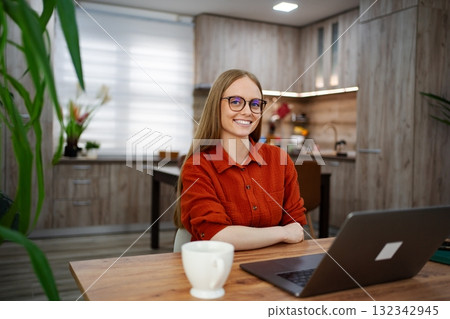 Young woman working from home in a stylish modern kitchen 132342945