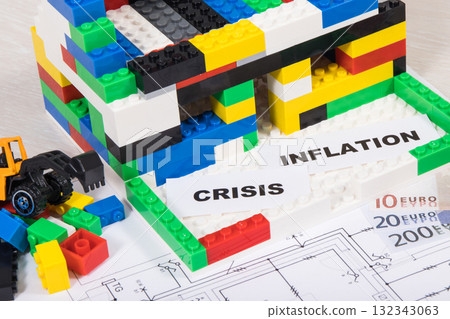 House under construction made of toy blocks, money, housing plan, inscription crisis and inflation 132343063
