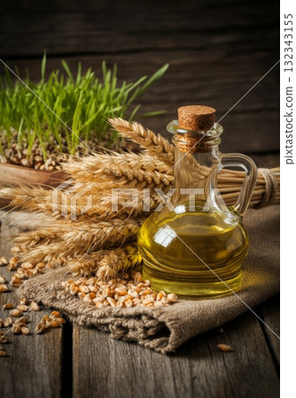 Olive oil bottle with wheat and grains on rustic wooden table representing isolation and exclusion 132343155