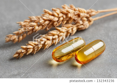 Golden capsules and wheat grains symbolize themes of ostracism and isolation in a minimalist setting Golden capsules and wheat grains symbolize themes of ostracism and isolation in a minimalist setting 132343156