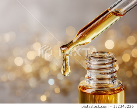 Transparent droplet of wheat germ oil suspended from pipette, symbolizing isolation and exclusion Transparent droplet of wheat germ oil suspended from pipette, symbolizing isolation and exclusion 132343226
